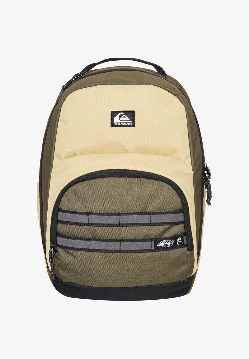 Two-tone beige and olive green Quiksilver backpack with front zip pocket, black base, and logo patches on top and front pocket.