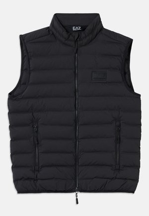 Black puffer vest featuring a high collar, front zipper, and two zippered side pockets. Made from quilted, lightweight material.