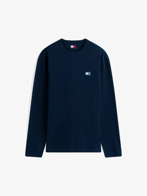 Granatowy t-shirt z długim rękawem wykonany z bawełny. Posiada małą naszywkę z logo na klatce piersiowej oraz okrągły dekolt. Gładka, lekka faktura.