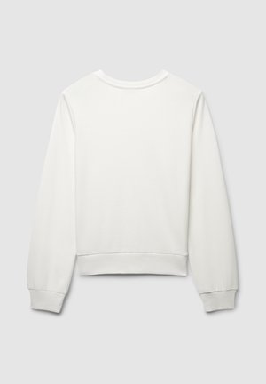 Sweatshirt blanc avec un col rond, des manches longues et un ourlet ajusté. Texture douce sans motifs visibles ni détails métalliques.