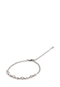 Ez egy ezüst lánc karkötő kerek karikákkal, tiszta drágakövekkel, fém díszítésekkel. Állítható záródás vékony hosszabbító lánccal.