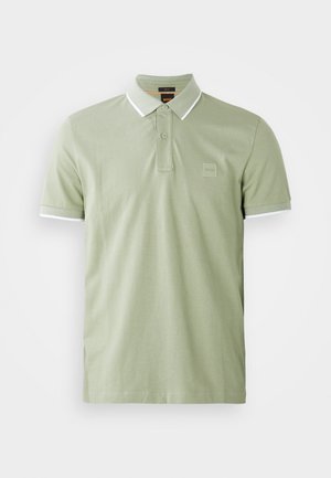 Light green polo shirt made of cotton, features a classic collar, two-button placket, and white trim on collar and sleeves. Square logo on chest.