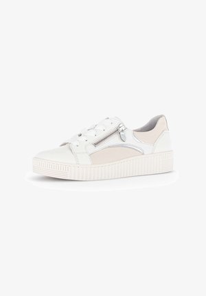 White low-top sneaker with thick ribbed sole, side zipper, lace-up front, and light beige suede accents.