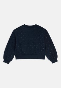 Námořnická mikina s kulatým výstřihem a nízko posazenými rameny. Obsahuje malé, rovnoměrně rozmístěné ozdoby a elastické manžety.