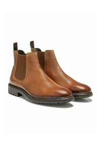 Bottes Chelsea en cuir marron avec des panneaux latéraux élastiques, bout rond et semelle en caoutchouc texturée pour une meilleure adhérence. Fini lisse et poli.
