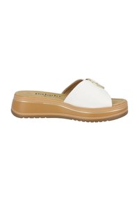 White slide sandals with a smooth synthetic upper, open toe design, and gold accent hardware. They feature a tan platform sole with textured grip.