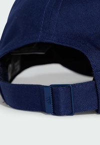 Navy blue cap with a textured fabric, curved brim, adjustable strap at the back featuring a plastic buckle for size adjustment.