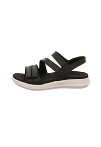 Schwarze Sandalen mit drei verstellbaren Riemen, einem weichen Fußbett und einer weißen, konturierten Gummisohle. Glatte Lederstruktur, minimalistischem Design.
