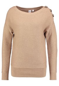 Beige ribstrikket sweater med bred halsudskæring, tekstureret stof og tre dekorative knapper på venstre skulder. Har lange ærmer og en tætsiddende kant.