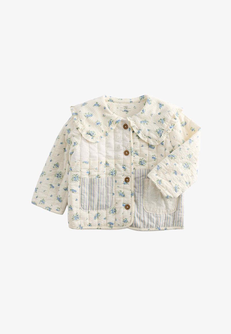 Cream quilted toddler jacket with blue floral print, striped and embroidered front pockets, wooden buttons, and a ruffled wide collar.