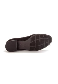 Black suede slip-on shoe with a textured rubber sole, featuring a round toe and minimal design. Logo embossed on the outsole.