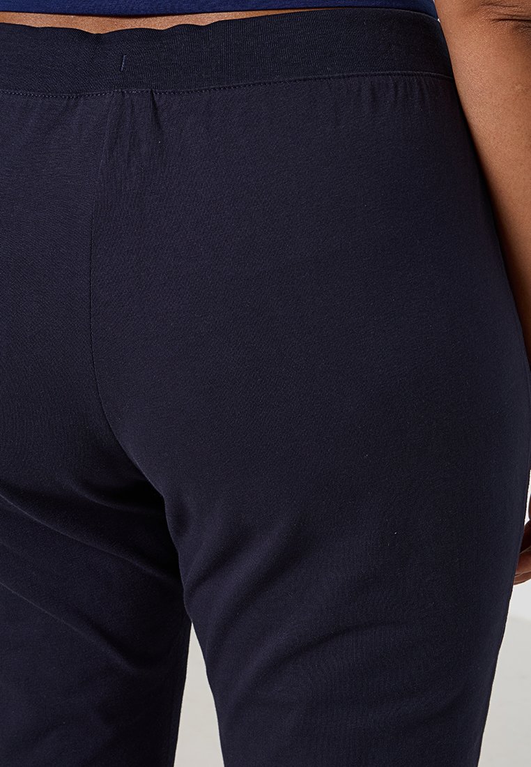 Navyblaue, dehnbare Baumwollleggins mit einem elastischen Bund, die eine glatte Textur und eine figurnahe Passform aufweisen.