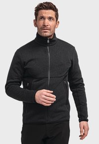 Schwarze Fleecejacke mit hohem Kragen, Reißverschluss vorne und seitlichen Taschen. Verfügt über einen strukturierten Stoff und kontrastierende schwarze Seitenelemente.