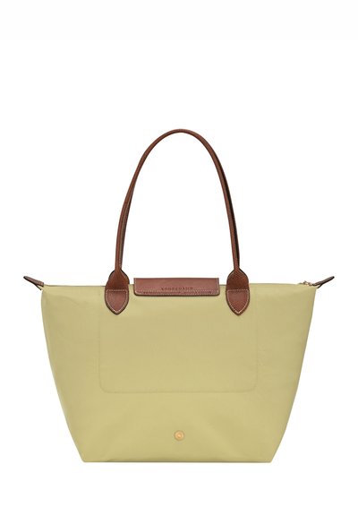 Light green tote bag made of nylon with brown leather accents, featuring two long handles and a front pocket. Zippered top closure.