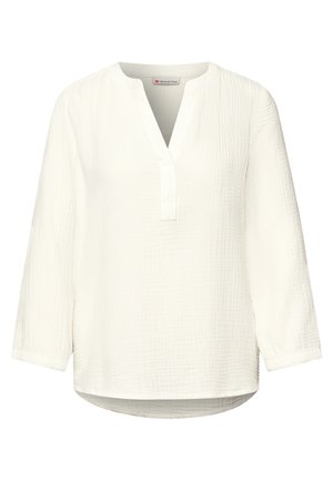 Blusa blanca de manga larga con textura, abertura en forma de V en el cuello y dobladillo redondeado, con un ajuste suelto y relajado.