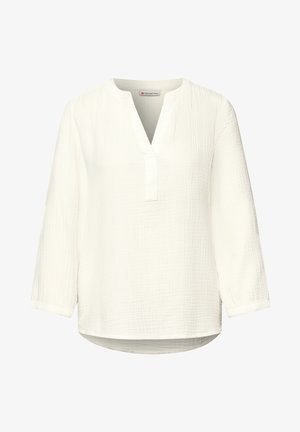 Bílá texturovaná halenka s dlouhým rukávem, výstřihem do V s rozparkem a zaobleným lemem, s volným a pohodlným střihem.