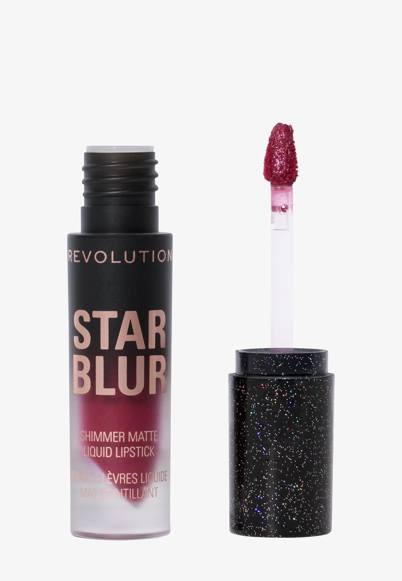 Flytande läppstift i en gradientfärgad tub som går från svart till lila med etiketten "STAR BLUR"; inkluderar ett glittrigt svart lock och applicator med en fluffig spets.