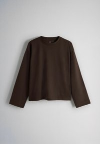 Dark brown long-sleeve crew neck shirt with a straight hem displayed against a light grey background.