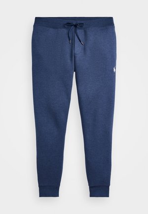 Marineblaue Jogginghose mit Kordelzug in der Taille, zulaufenden Beinen, gerippten Bündchen und kleinem weißem gesticktem Logo am rechten Oberschenkel.