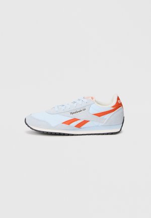 Baskets Reebok bleu clair et gris avec des bandes de logo orange et une semelle noire, vues du côté extérieur sur fond blanc.