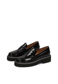 Black leather loafers with a glossy finish, featuring a double strap detail, thick white stitching, and a chunky black rubber sole.