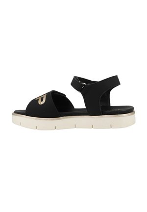 Black sandal with open toe and ankle strap; features a thick white sole and gold accents on the upper surface. Matte texture with minimal design.