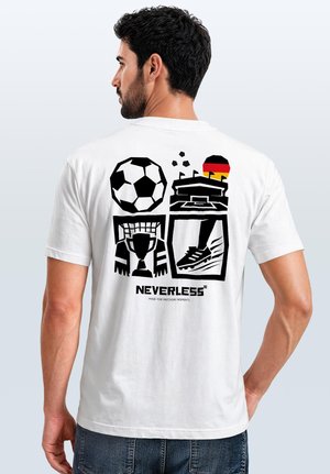 Man wearing white t-shirt with black graphic of soccer ball, stadium, trophy, shoe, and German flag on the back.