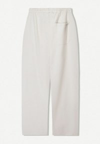 Light beige, loose-fitting trousers with an elastic waistband and a single back pocket. Made from a soft, textured fabric.