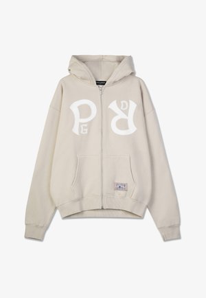 Kreemjas lukuga kapuutsiga särk, mis on valmistatud pehmest materiialist, suur valge logo rinna peal, esiküljel taskud ja reguleeritav kapuuts.