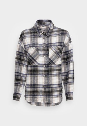 Chemise-veste à manches longues avec motif à carreaux noir, blanc et bleu, deux poches poitrine et un col.