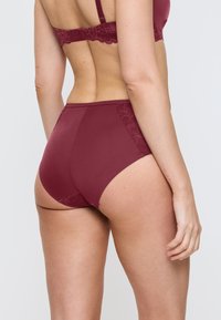 Burgundowe majtki o podwyższonym stanie z koronkowym akcentem po obu stronach i gładkim, matowym wykończeniu z tyłu, zapewniające pełne pokrycie.