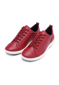 Red leather athletic shoes with round toe, textured upper, and white rubber sole. Features laces and pull tab at the heel.
