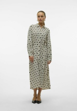 Long-sleeve shirt dress in cream with a black diamond pattern, self-tie belt, and buttoned front. Smooth fabric, ankle-length design.