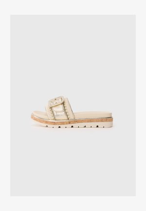 Sandalias de slide metálicas doradas con una correa trenzada, plantilla forrada de corcho y una suela exterior de goma texturizada. El diseño presenta un gran acento de hebilla.