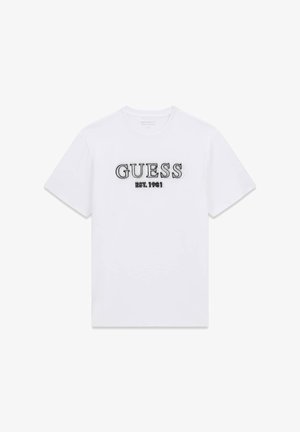 T-shirt en coton blanc avec "GUESS" brodé en noir, et "EST. 1981" en texte plus petit en dessous. Design classique à col rond.