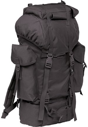 Black rugged backpack with multiple straps, top closure, two side pockets, and reinforced bottom. Made from durable fabric for outdoor use.