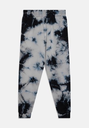 Czarno-białe spodnie dresowe z wzorem tie-dye, z elastycznym pasem i ściągaczami, z małym logo Nike na górnej części lewej nogawki.