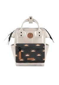 Silver metallic backpack with a structured design, black front pocket featuring sunrise pattern, leather accents, and double top handles.