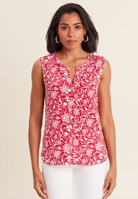 Blusa rossa senza maniche con un motivo floreale bianco, dotata di una patta di bottoni parziale e un collo arrotondato, realizzata in tessuto leggero.