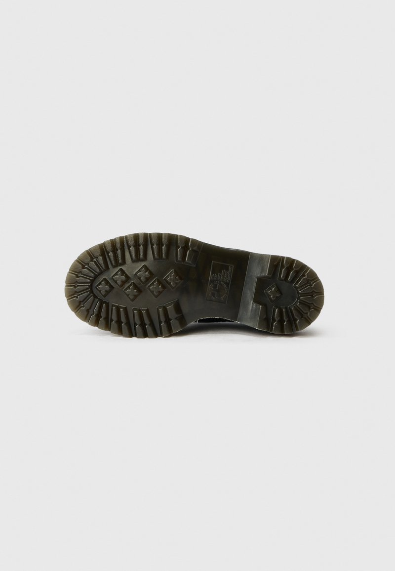 Sole of a black boot with deep tread patterns, including cross shapes and rectangular lugs, displayed on a white background.