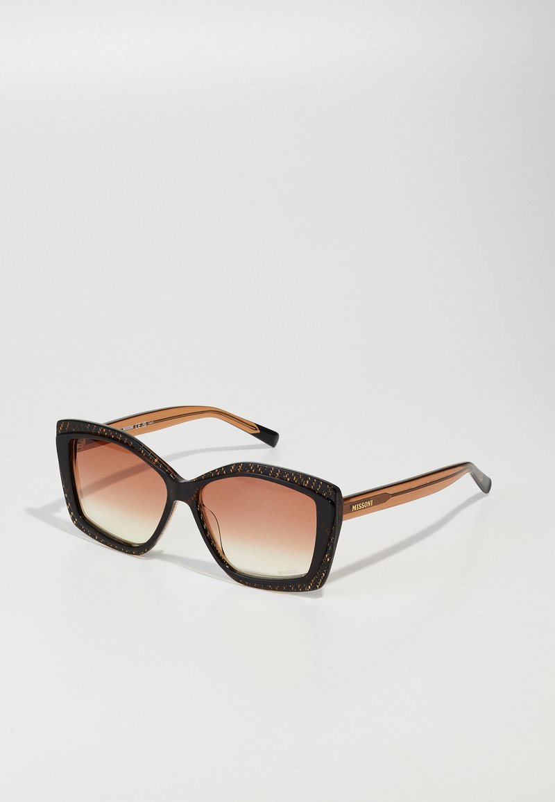 Oversized, geometric sunglasses with a black and brown tortoiseshell frame; gradient lenses; branded arms in a warm brown tone.