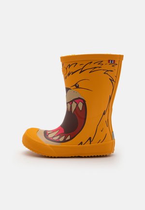 Botte de pluie en caoutchouc orange avec un design de visage d'animal rugissant montrant des dents pointues et une bouche ouverte sur le côté.