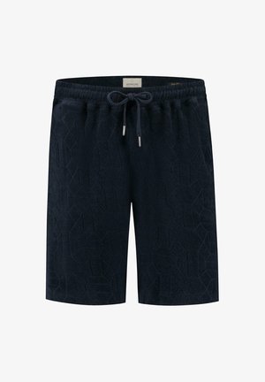 Pantalones cortos azul marino hechos de una tela texturizada con un patrón geométrico. Cintura elástica con cordón ajustable y puntas de metal plateadas.