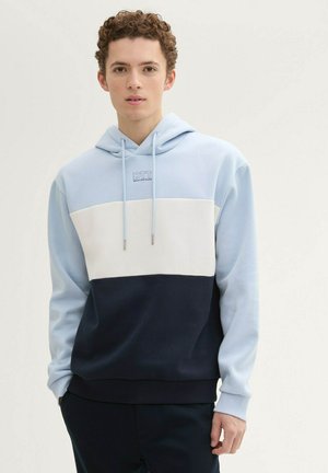 Light blue and navy color-blocked hoodie in soft material, featuring a drawstring hood, front pouch pocket, and embroidered logo on the chest.