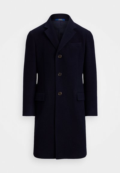 Námořnický vlněný kabát s vyprofilovaným límcem, se čtyřmi knoflíky vpředu a dvěma předními kapsami. Hladká textura a přizpůsobený střih.