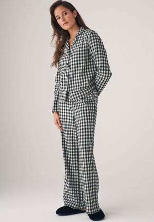 Set di pigiama a motivo gessato in blu navy e bianco con camicia a bottoni con colletto e pantaloni a gamba larga. Tessuto morbido, vestibilità rilassata. Pantofole nere.