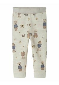 Krämliknande babyleggings med tryck av nallebjörnar och leksakståg, med björnar i blå jackor och bruna byxor.