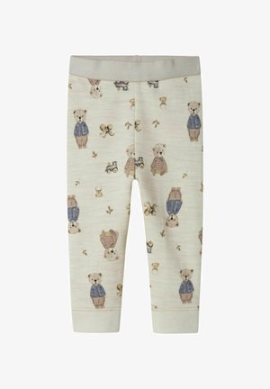 Leggings pour bébé couleur crème avec un motif de ours en peluche et de train jouet, présentant des ours en vestes bleues et en pantalons bruns.