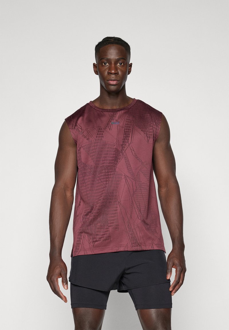 Burgunderfarbenes ärmelloses Sporttop mit einem strukturierten geometrischen Muster; kombiniert mit schwarzen Sportshorts. Der Stoff wirkt leicht und atmungsaktiv.