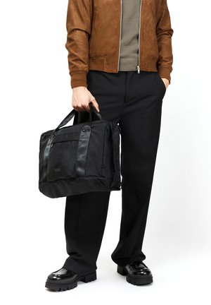 Black fabric messenger bag with dual handles, contrast black leather accents, front zippered pocket, rectangular shape, and sleek design.